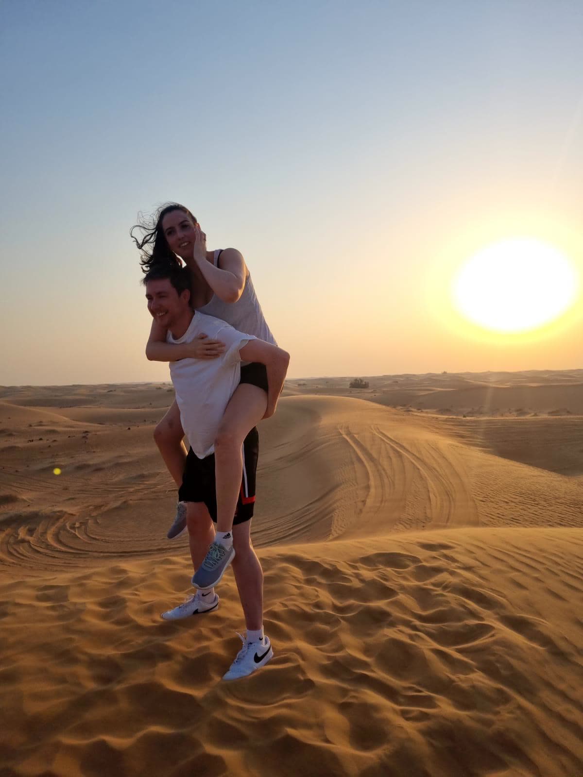 A piggyback on a desert dune at sunset in Dubai