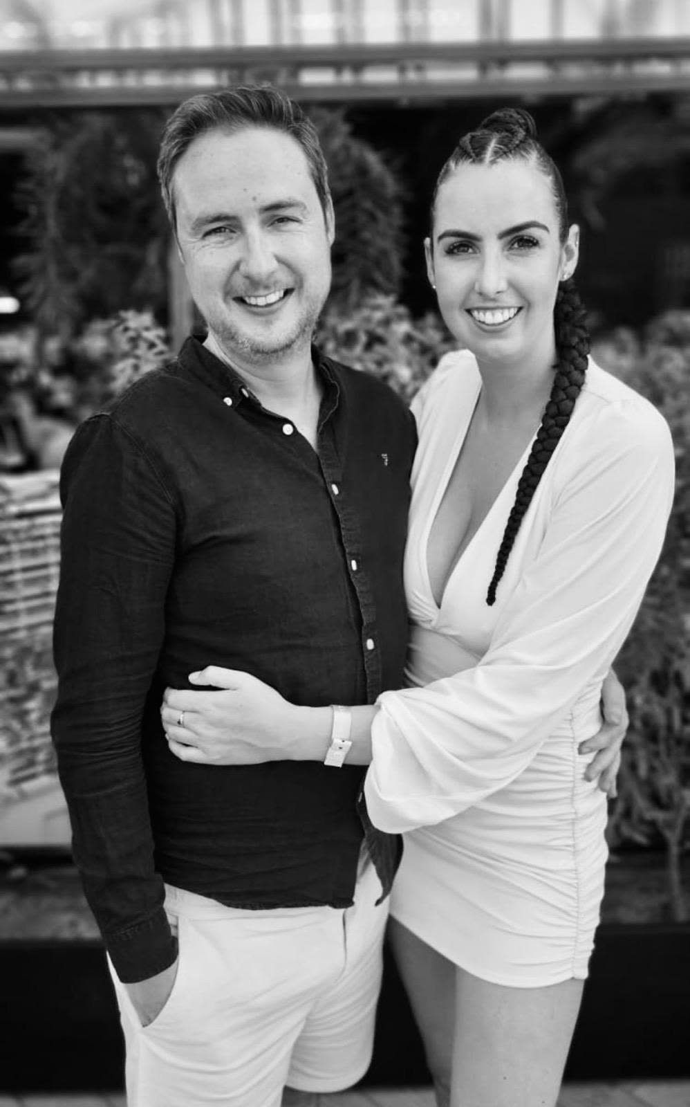 A black and white portrait, both dressed up