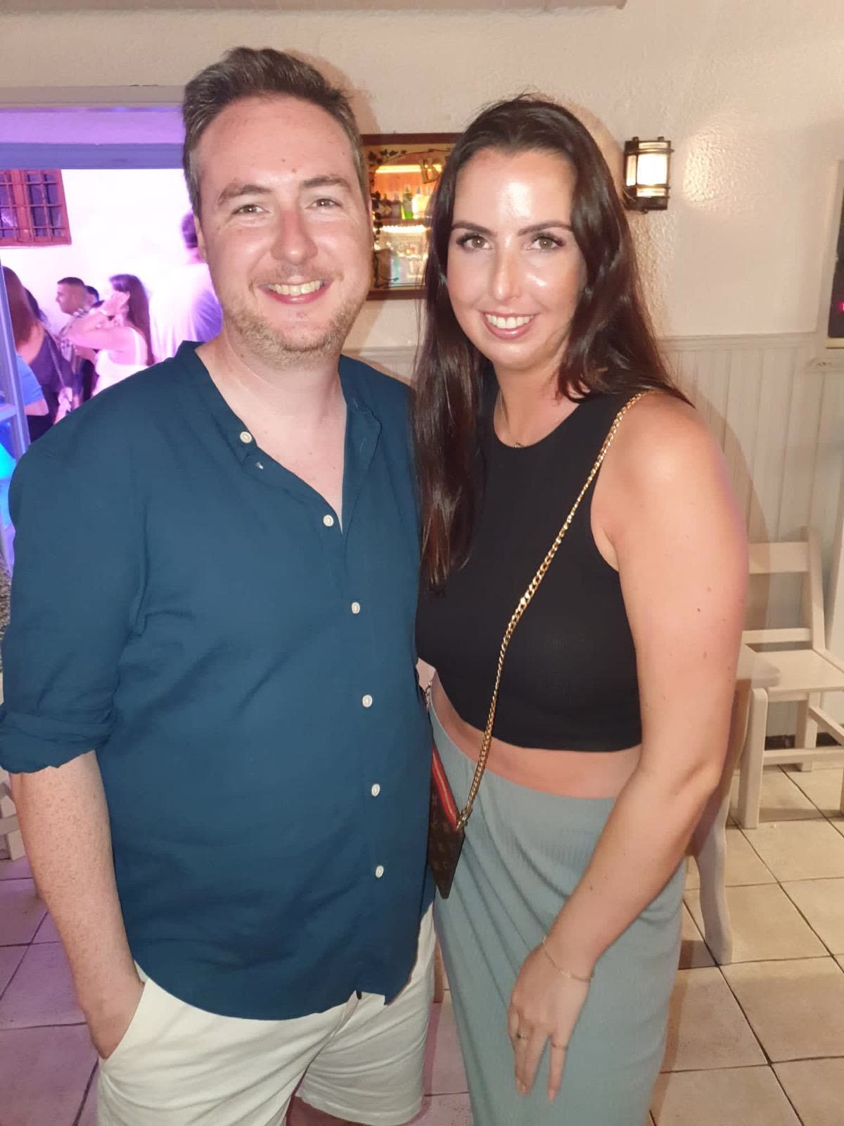 Orlaith and Niall out on the town at night, dressed up and laughing